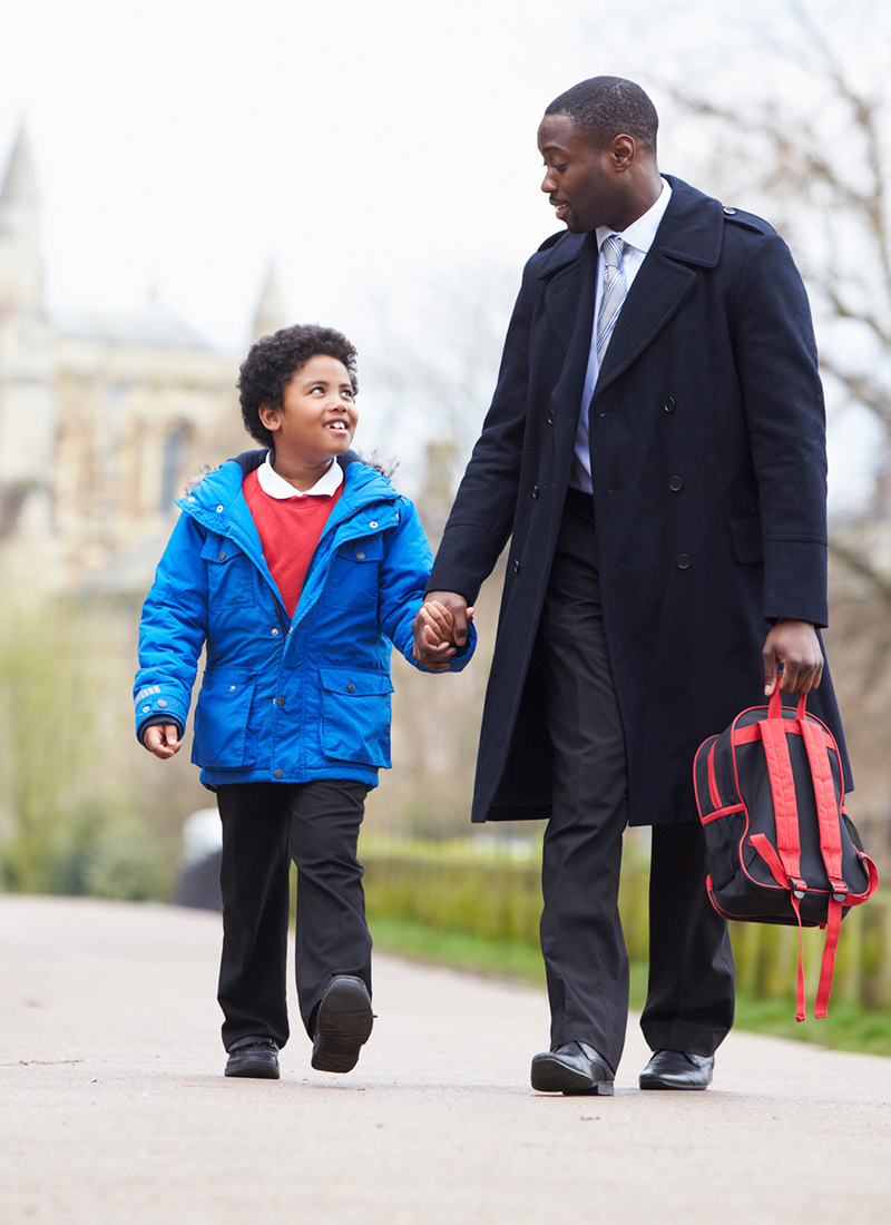 Man walking son to school