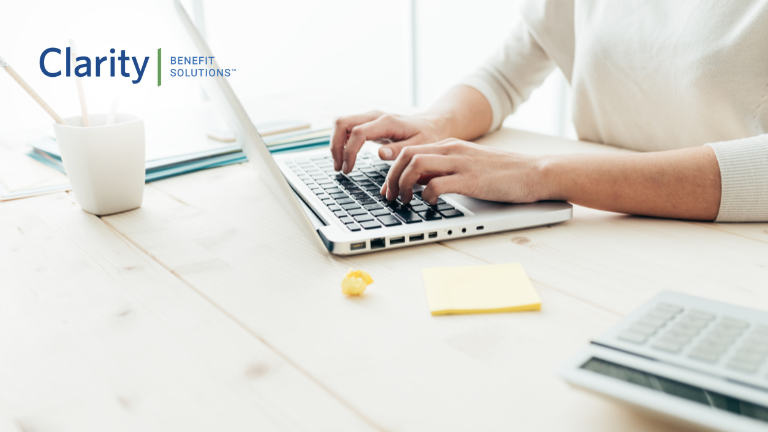 Clarity Benefit Solutions person using a laptop to streamline their benefits